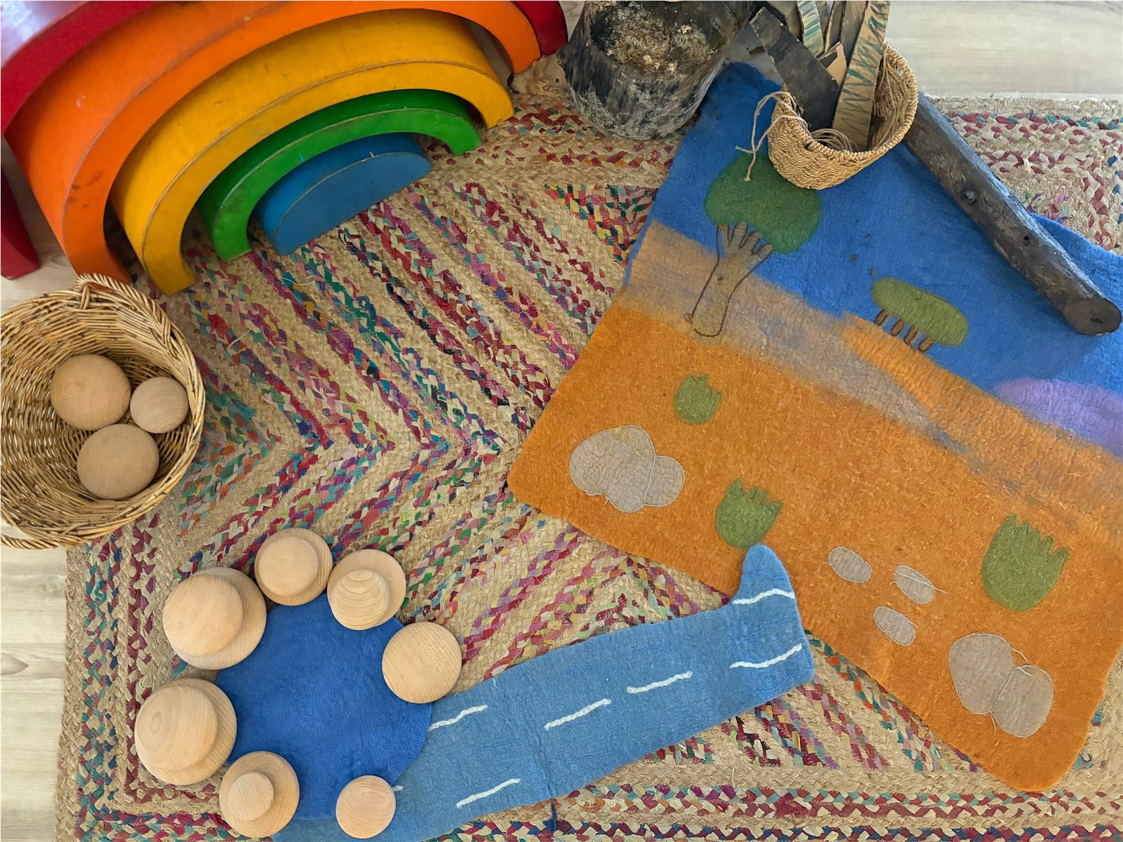 Montessori-inspired learning materials and a hand-felted play landscape at BrightSteps