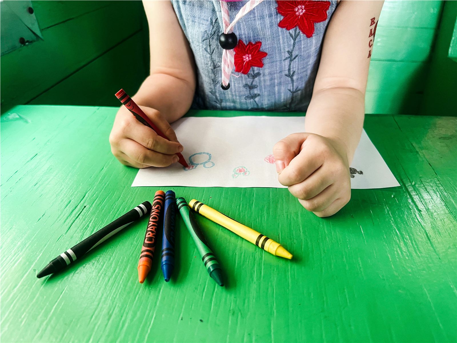 Preschooler doing a hands-on Montessori threading activity